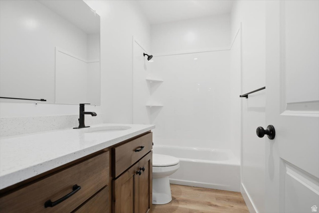 164 North 400 East Preston, ID 83263 - Photo 13 of 21 Bathroom featuring a wood-finish vanity with a light-toned countertop, undermount sink, and matte black faucet