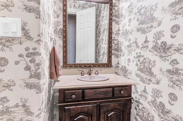 a large kitchen with kitchen island granite countertop a large counter top stainless steel appliances a large window and cabinets