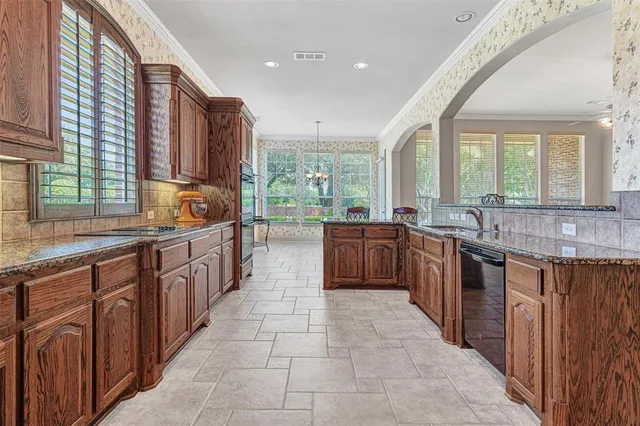 a kitchen with stainless steel appliances granite countertop a refrigerator and wooden cabinets