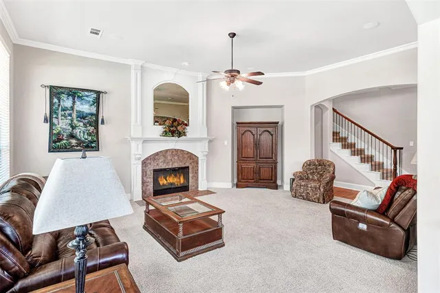 a living room with furniture fireplace and flat screen tv