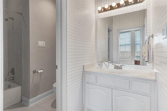 a room with pool table and windows