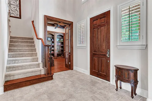 a living room with furniture and a book shelf