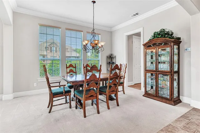 a view of a dining room with furniture and window