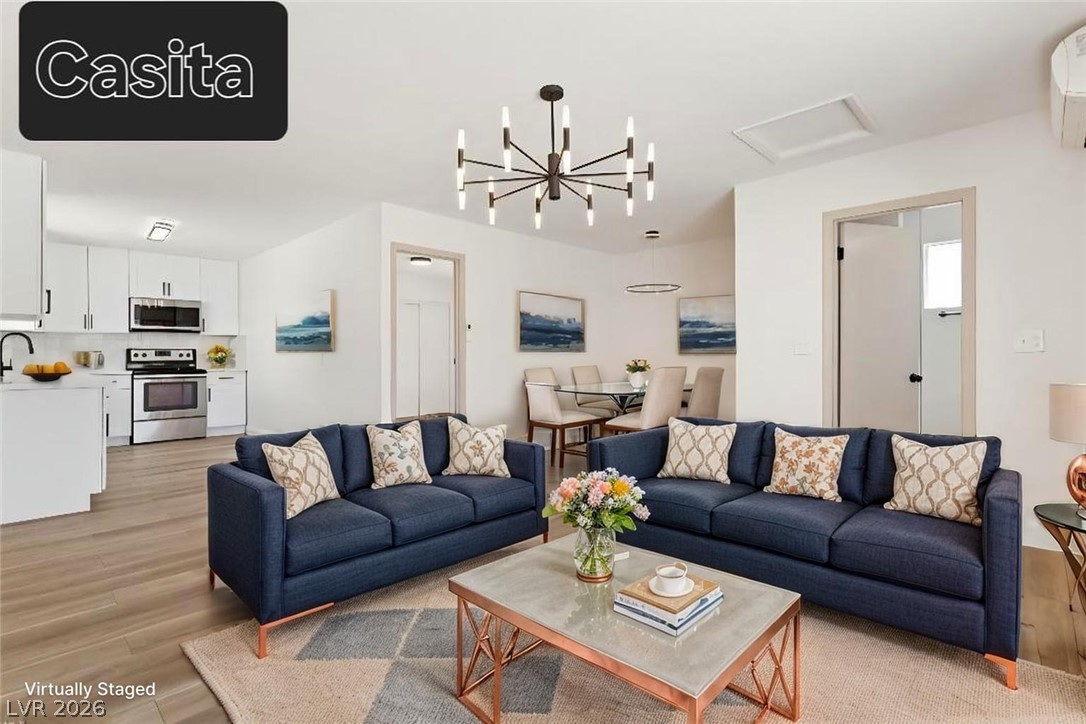 3420 West Warm Springs Road Las Vegas, NV 89118 - Photo 13 of 50 Living area with hanging lights, light wood-type flooring, and a wall mounted mini split