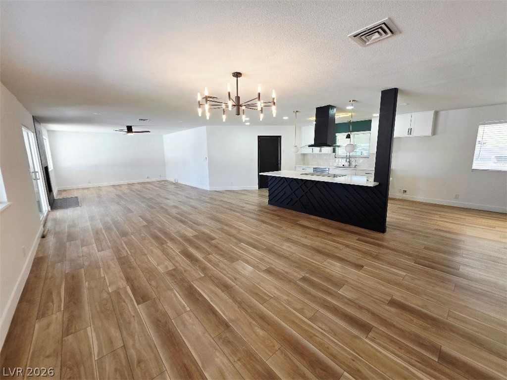 3420 West Warm Springs Road Las Vegas, NV 89118 - Photo 21 of 50 living room with a chandelier, light wood-style floors, and ceiling fan