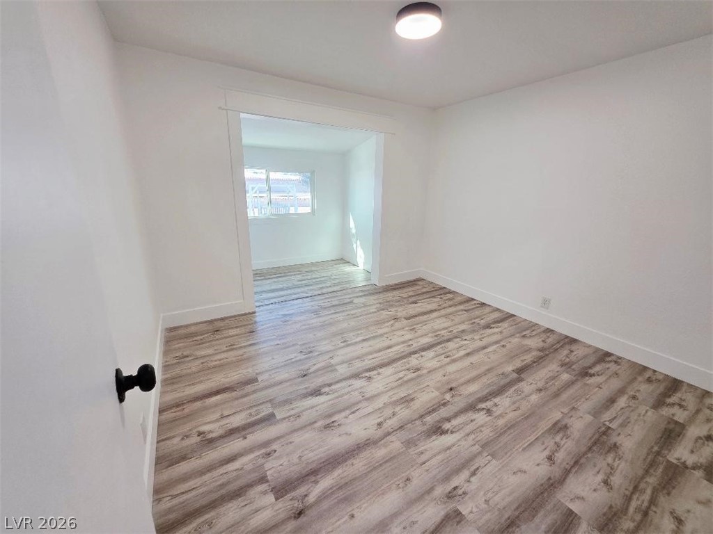 3420 West Warm Springs Road Las Vegas, NV 89118 - Photo 30 of 50 Bedroom 1 featuring light wood-style flooring and baseboards sitting area