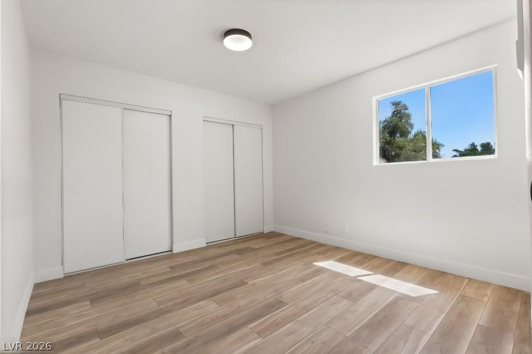 3420 West Warm Springs Road Las Vegas, NV 89118 - Photo 36 of 50 casita bedroom featuring multiple closets and light wood-style flooring
