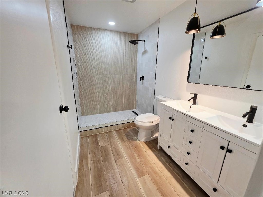 3420 West Warm Springs Road Las Vegas, NV 89118 - Photo 8 of 50 Primary Full bath with double vanity, a stall shower, and light wood-type flooring