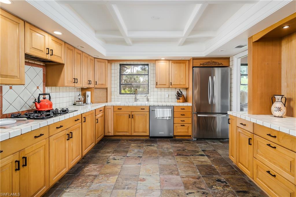 3301 31st Avenue Southwest Naples, FL 34117 - Photo 5 of 22 a kitchen with sink cabinets and window