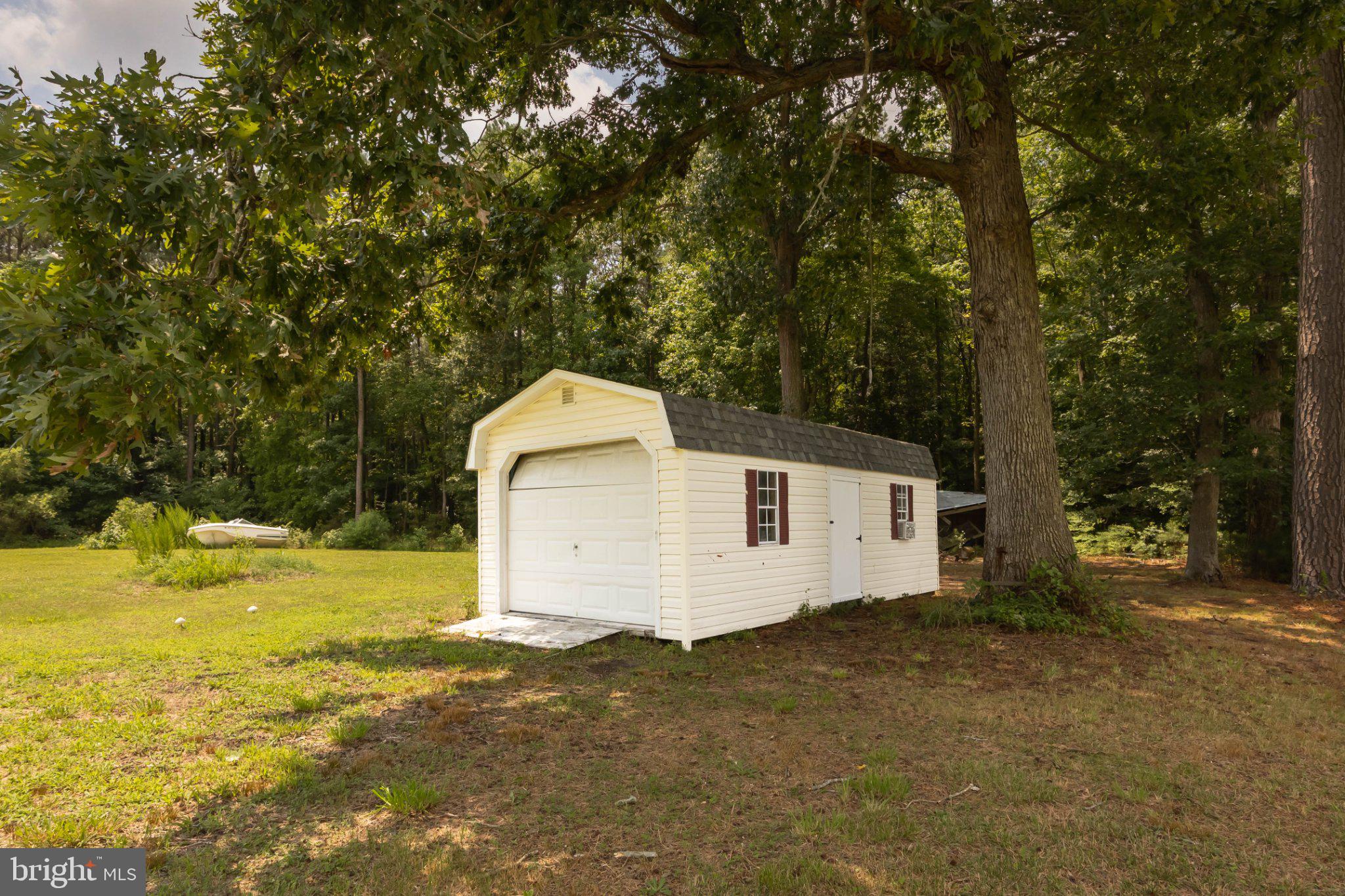 465 Hall Road Pocomoke City, MD 21851 - Photo 43 of 43 Charming shed nestled in nature's embrace.