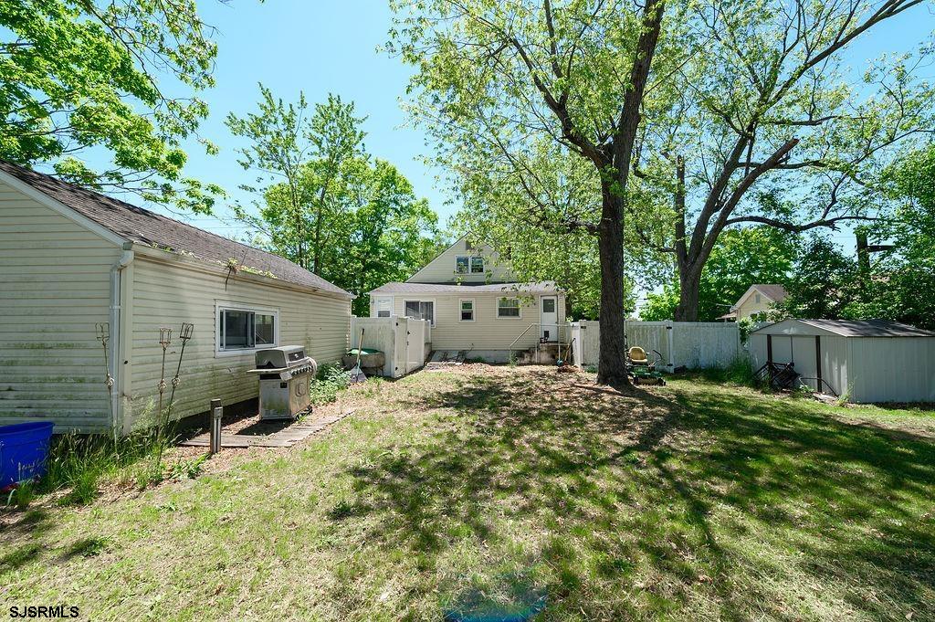 19 South 1st Road Hammonton, NJ 08037 - Photo 30 of 36 a backyard of a house with wooden fence and a tree