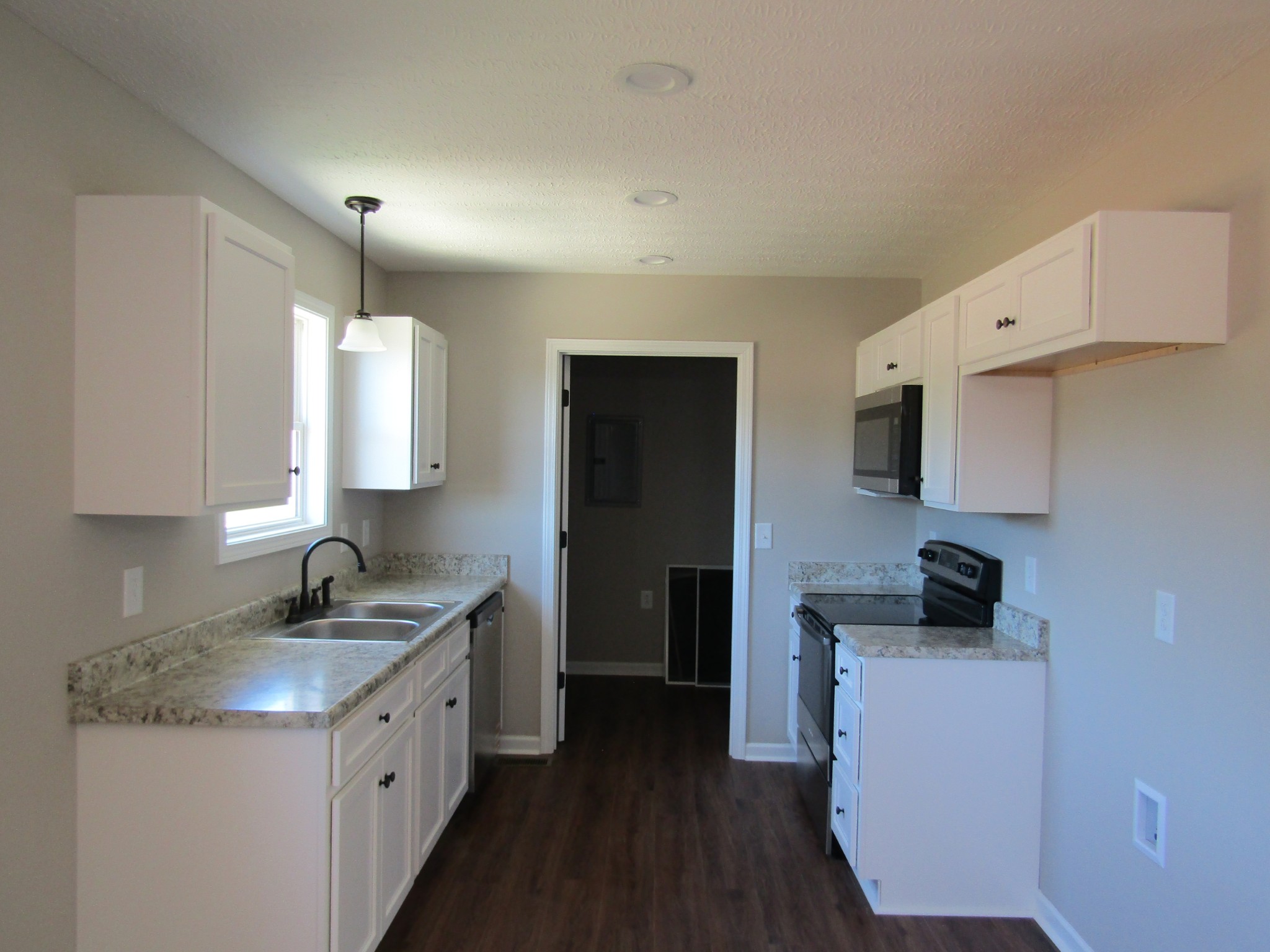 480 Crescent Factory Road Lawrenceburg, TN 38464 - Photo 6 of 14 a kitchen with granite countertop a sink and a stove top oven