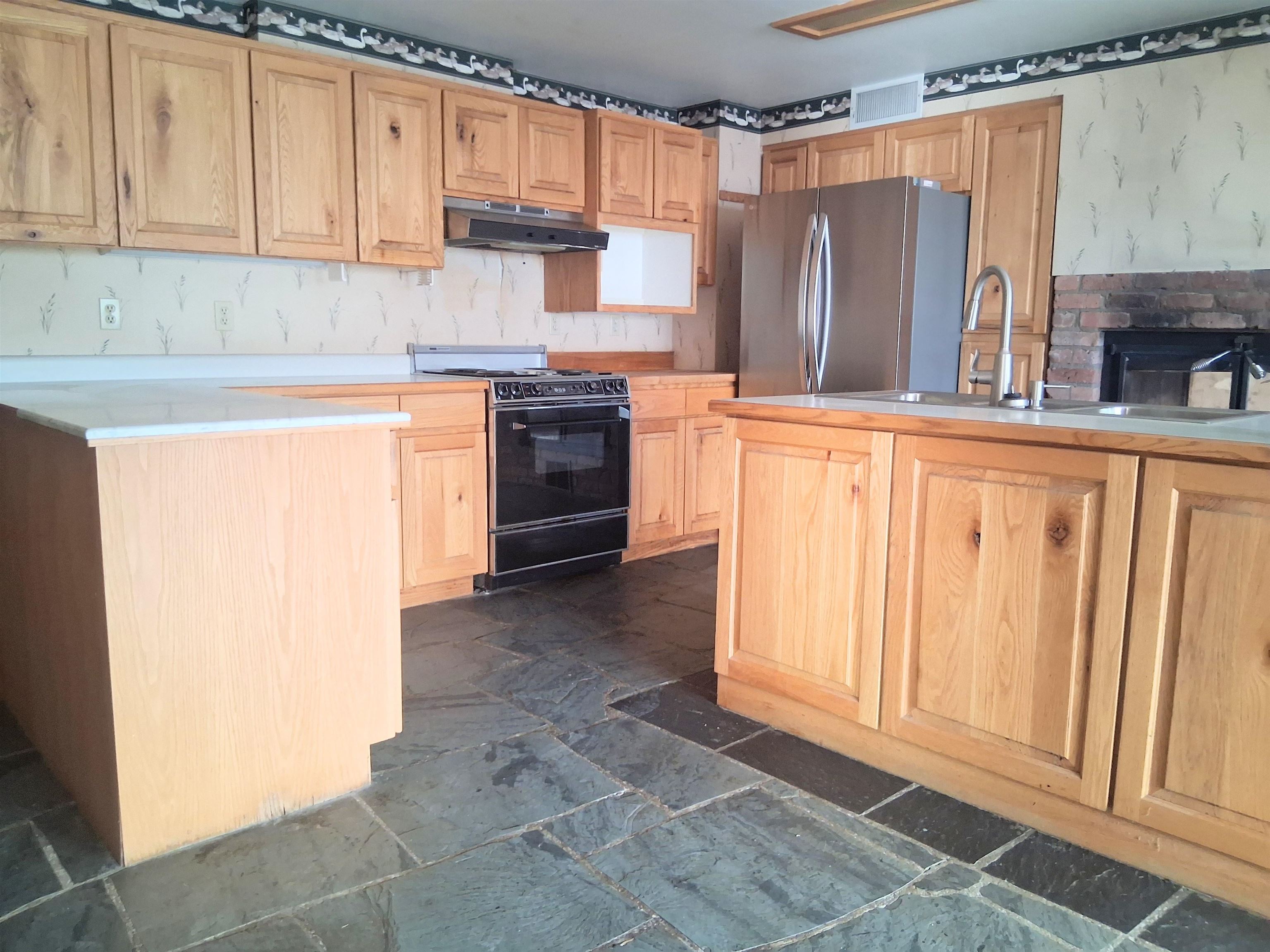 1983 River Road Fruita, CO 81521 - Photo 30 of 31 a kitchen with stainless steel appliances a refrigerator sink and cabinets
