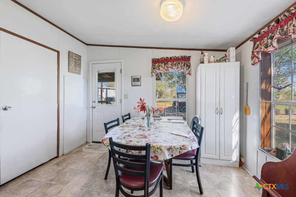 2632 Slickfield Road Yorktown, TX 78164 - Photo 11 of 33 a view of a dining room with furniture and a large window