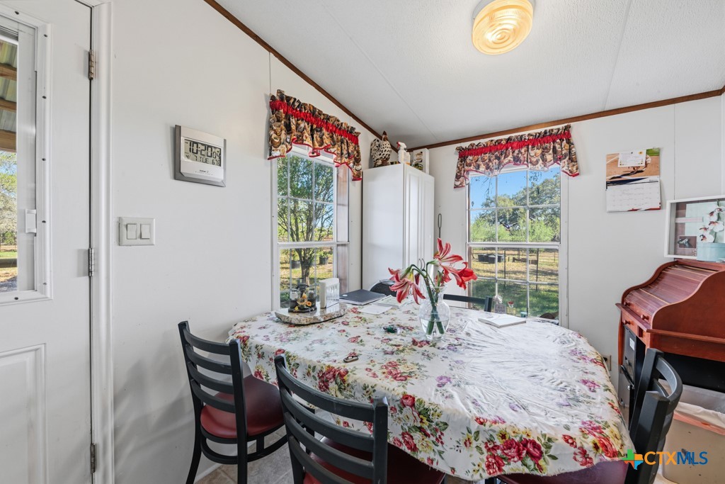 2632 Slickfield Road Yorktown, TX 78164 - Photo 12 of 33 a view of a dining room with furniture and window