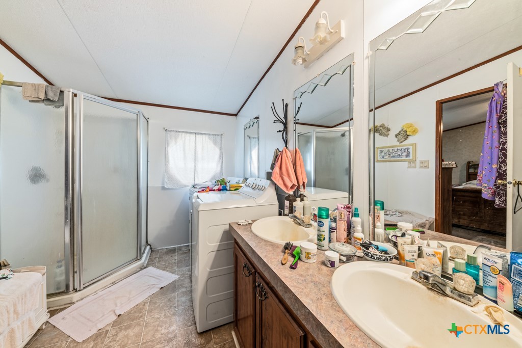 2632 Slickfield Road Yorktown, TX 78164 - Photo 14 of 33 a bathroom with a granite countertop sink mirror and shower