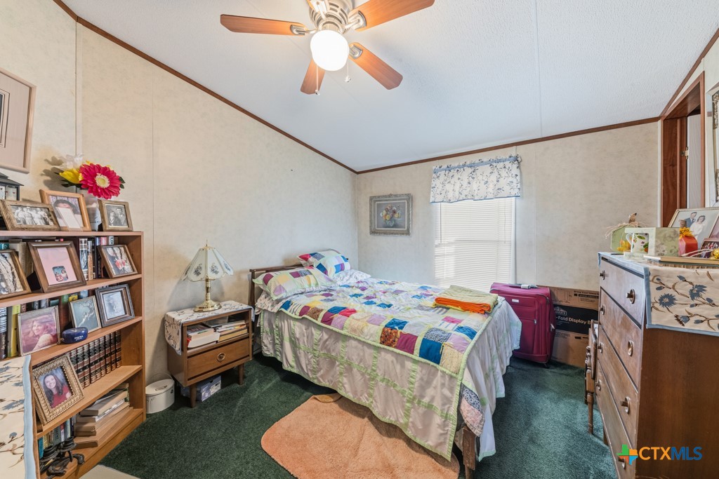 2632 Slickfield Road Yorktown, TX 78164 - Photo 15 of 33 a bedroom with a bed and a book shelf