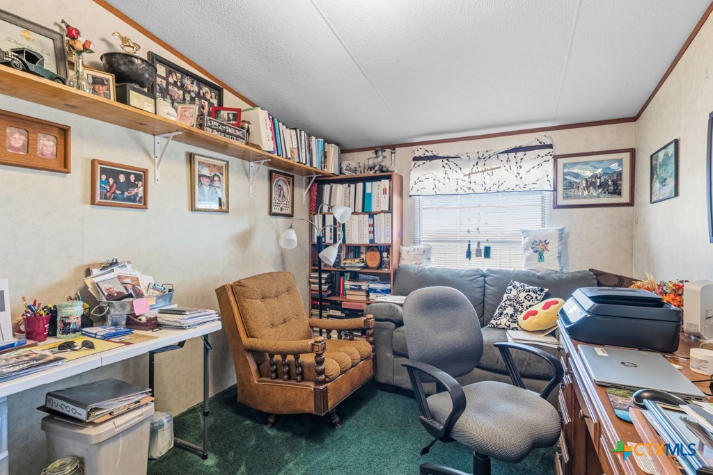 2632 Slickfield Road Yorktown, TX 78164 - Photo 17 of 33 a living room with furniture and a book shelf