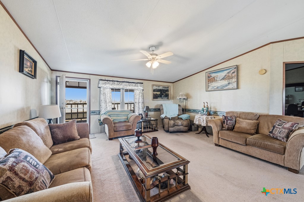 2632 Slickfield Road Yorktown, TX 78164 - Photo 7 of 33 a living room with furniture ceiling fan and a rug