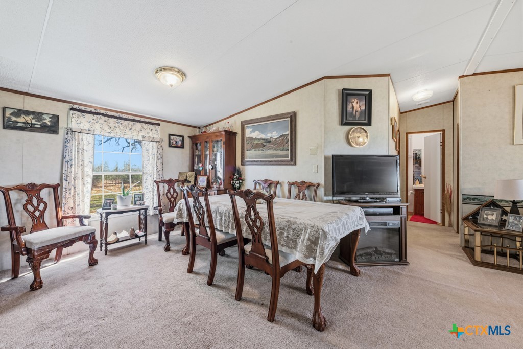 2632 Slickfield Road Yorktown, TX 78164 - Photo 8 of 33 a view of a livingroom with furniture and a flat screen tv