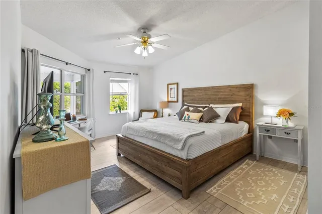 a bedroom with a bed and a flat tv screen on dresser