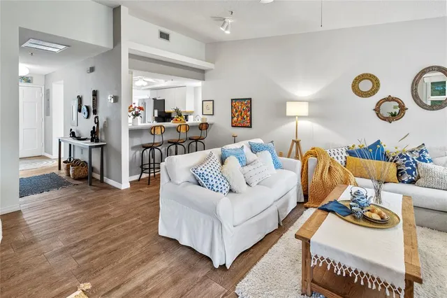a living room with furniture and wall clock