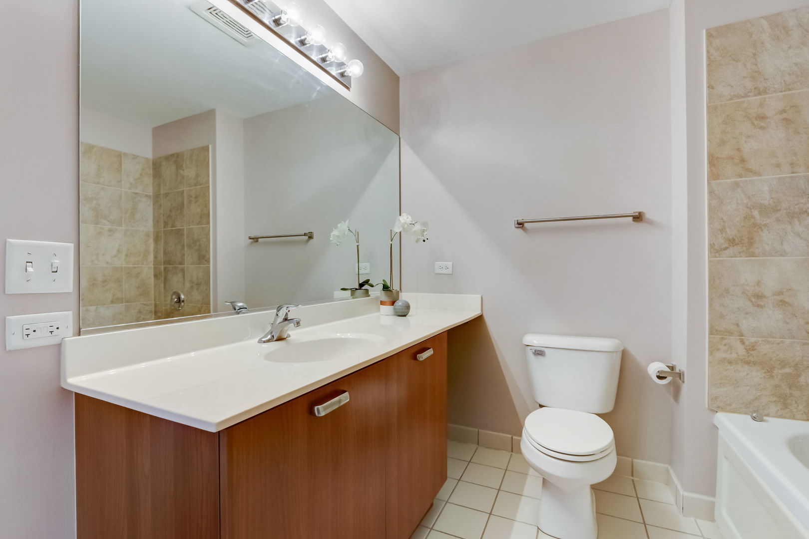 111 South Morgan Street, Unit 505 Chicago, IL 60607 - Photo 13 of 23 a bathroom with a sink toilet and mirror