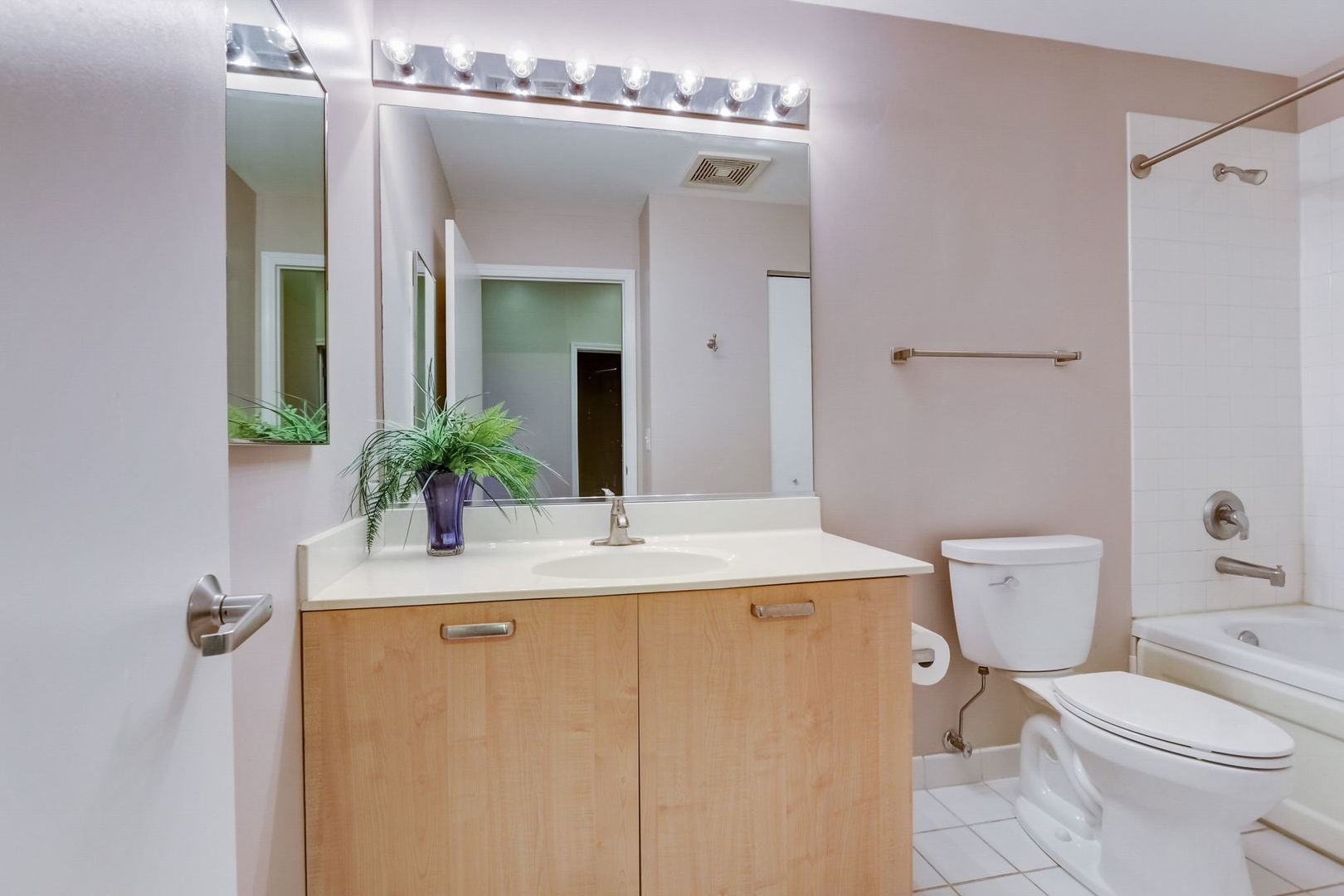111 South Morgan Street, Unit 505 Chicago, IL 60607 - Photo 17 of 23 a bathroom with a granite countertop sink a toilet and mirror