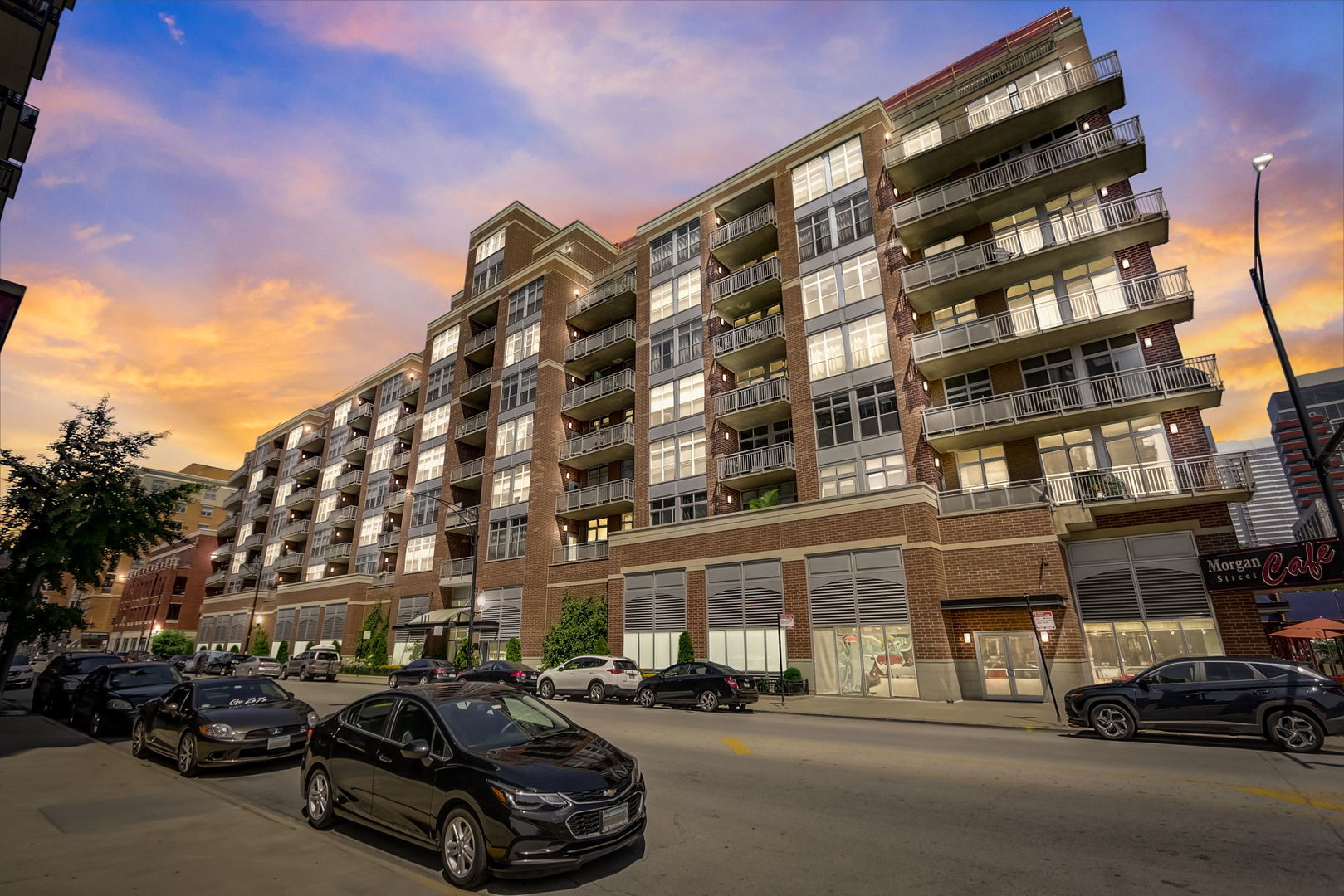 111 South Morgan Street, Unit 505 Chicago, IL 60607 - Photo 22 of 23 a city street lined with parked cars front of buildings