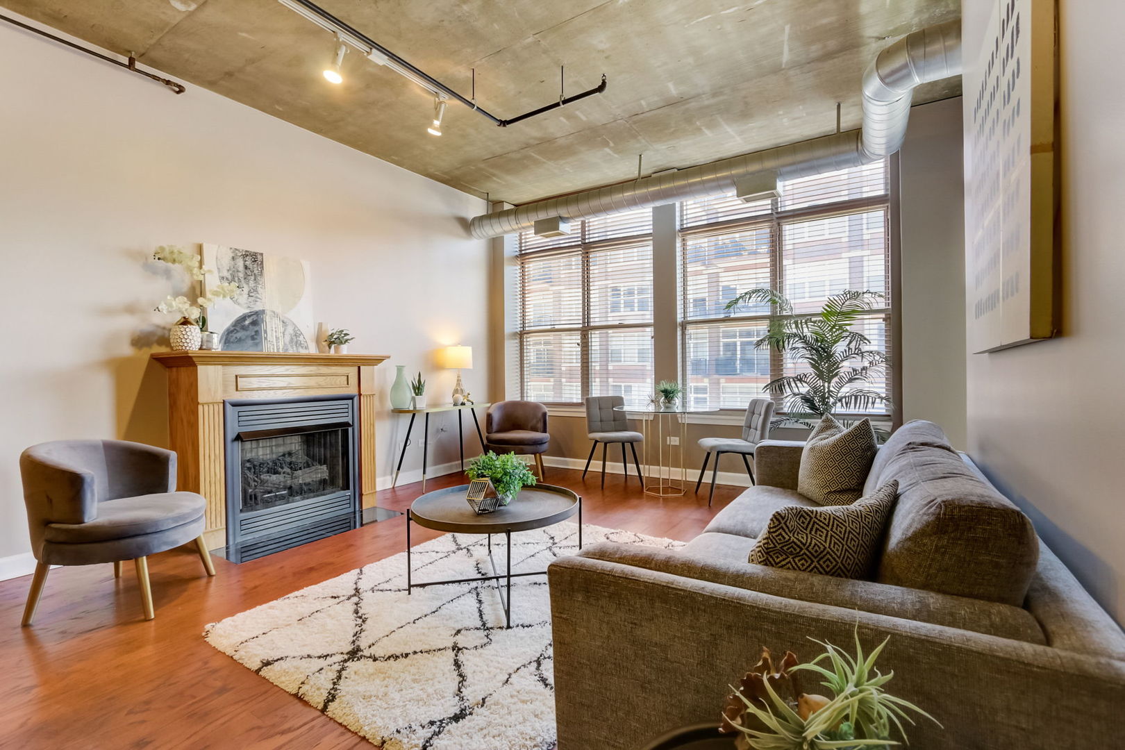 111 South Morgan Street, Unit 505 Chicago, IL 60607 - Photo 7 of 23 a living room with furniture and a fireplace