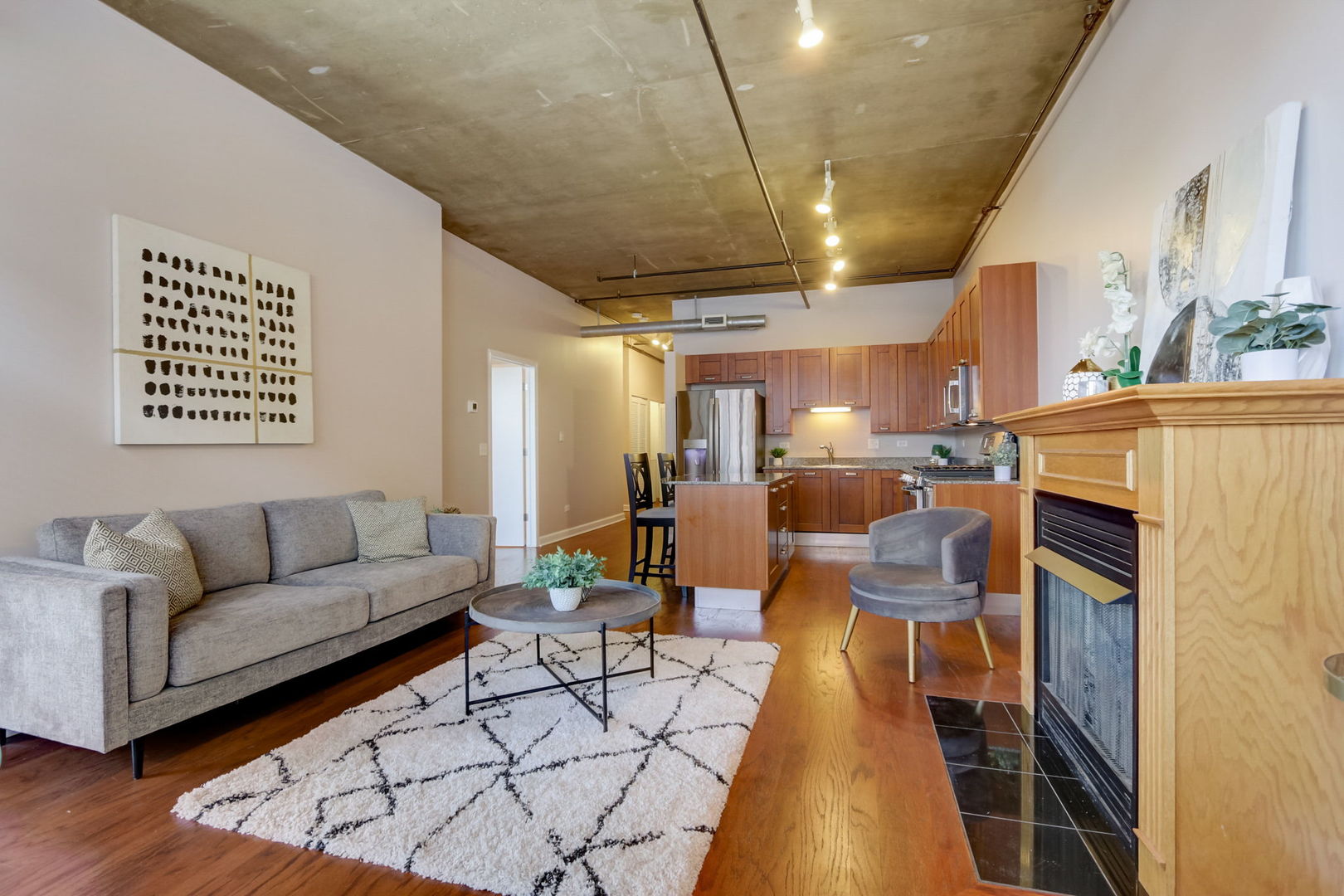 111 South Morgan Street, Unit 505 Chicago, IL 60607 - Photo 10 of 23 a living room with furniture and a fireplace