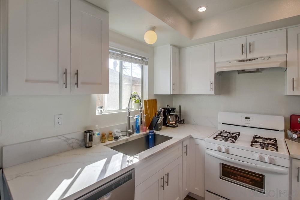 1122 11th Street Imperial Beach, CA 91932 - Photo 14 of 23 a kitchen with a sink stove and cabinets