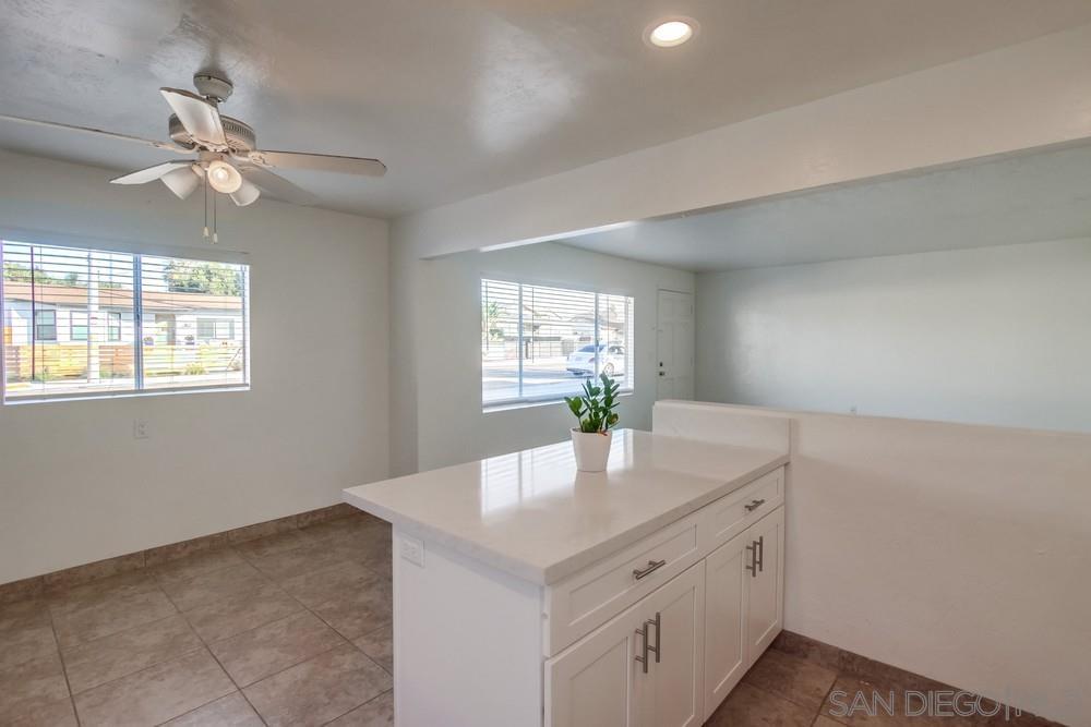 1122 11th Street Imperial Beach, CA 91932 - Photo 6 of 23 a kitchen with kitchen island granite countertop white cabinets and window