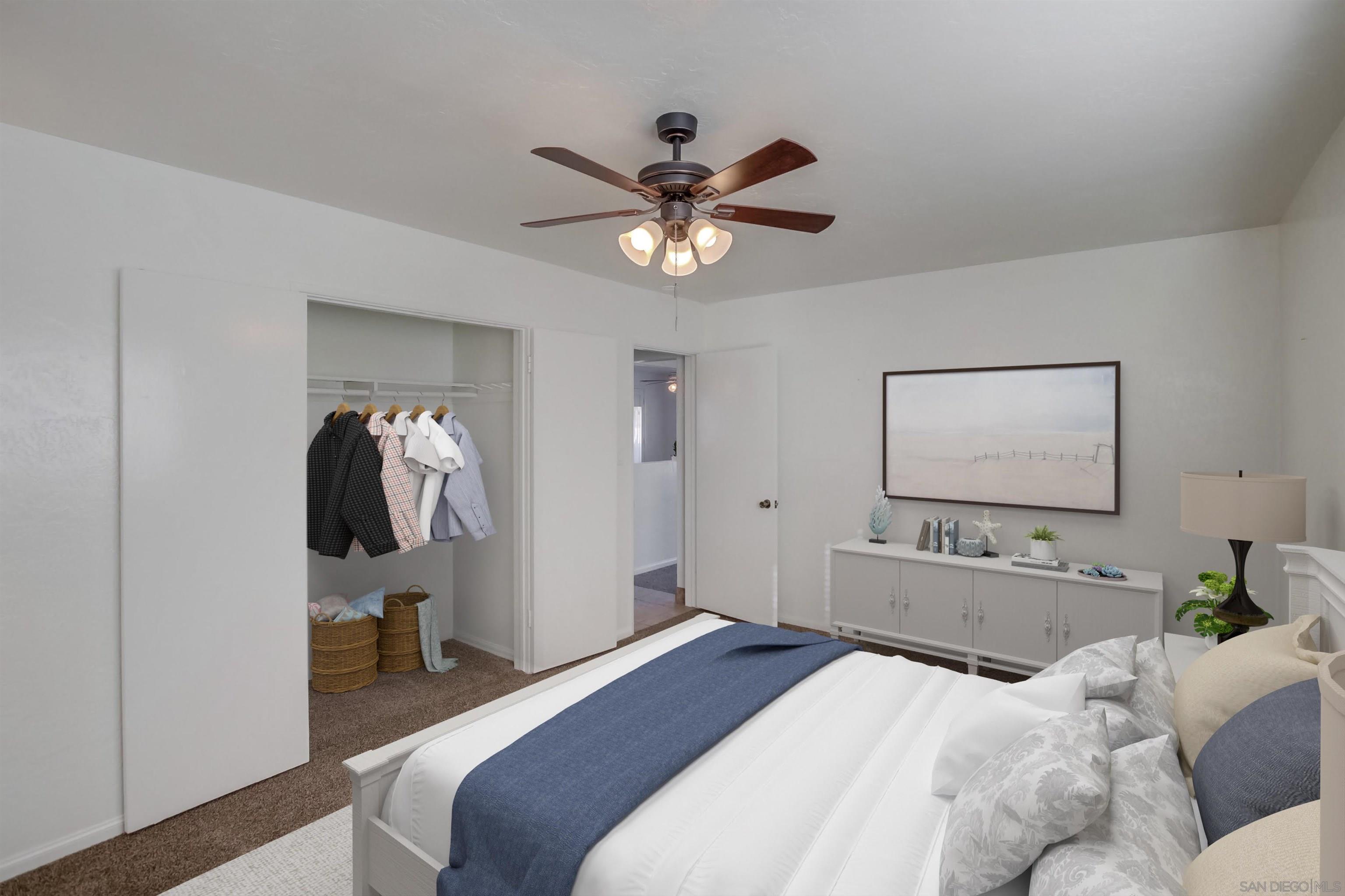 1122 11th Street Imperial Beach, CA 91932 - Photo 8 of 23 a bedroom with a bed and ceiling fan