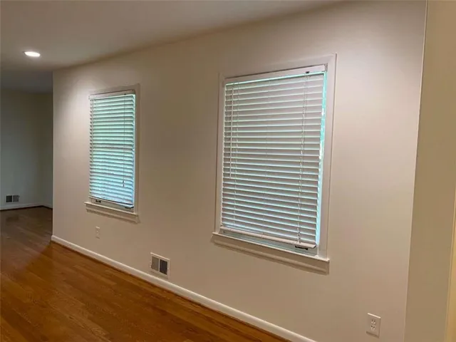 a view of a chandelier in big room with wooden floor