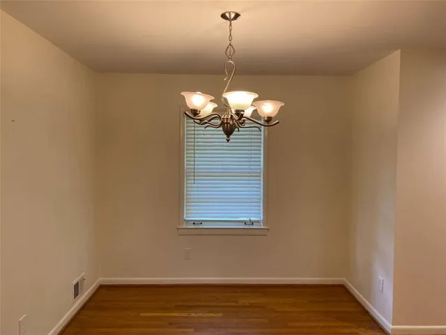 a view of hallway with wooden floor and stairs