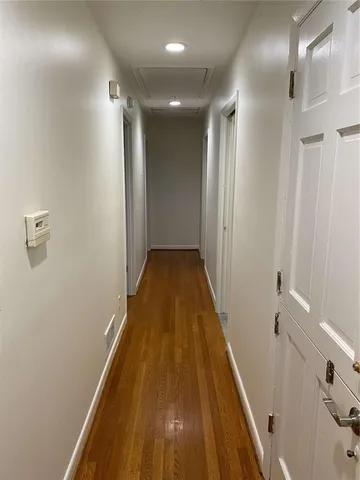 a bathroom with a granite countertop toilet sink and mirror