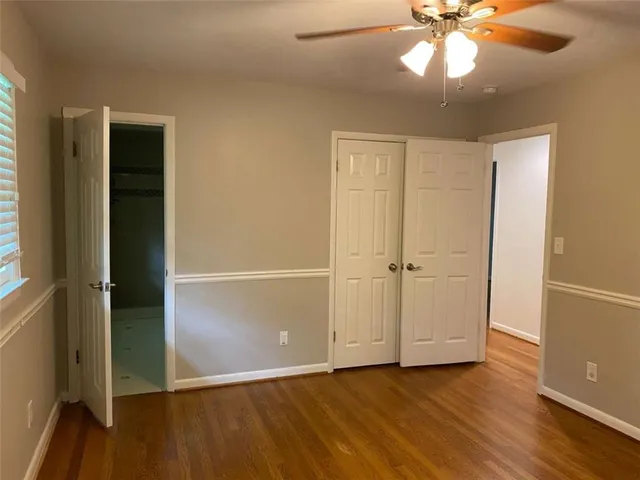 a bathroom with a granite countertop sink a toilet and shower