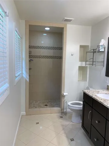 a bathroom with a granite countertop sink and mirror