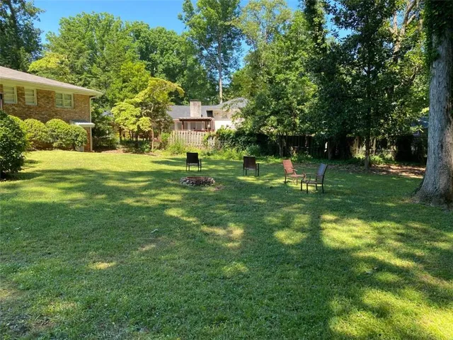 a view of deck with wooden floor and fence next to a yard
