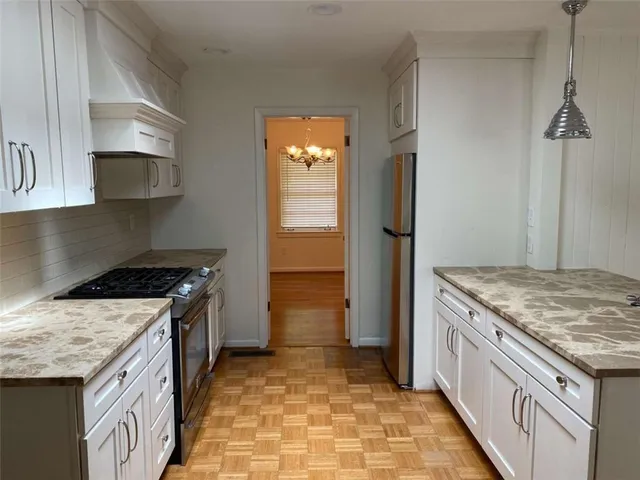 a kitchen with a stove and a sink
