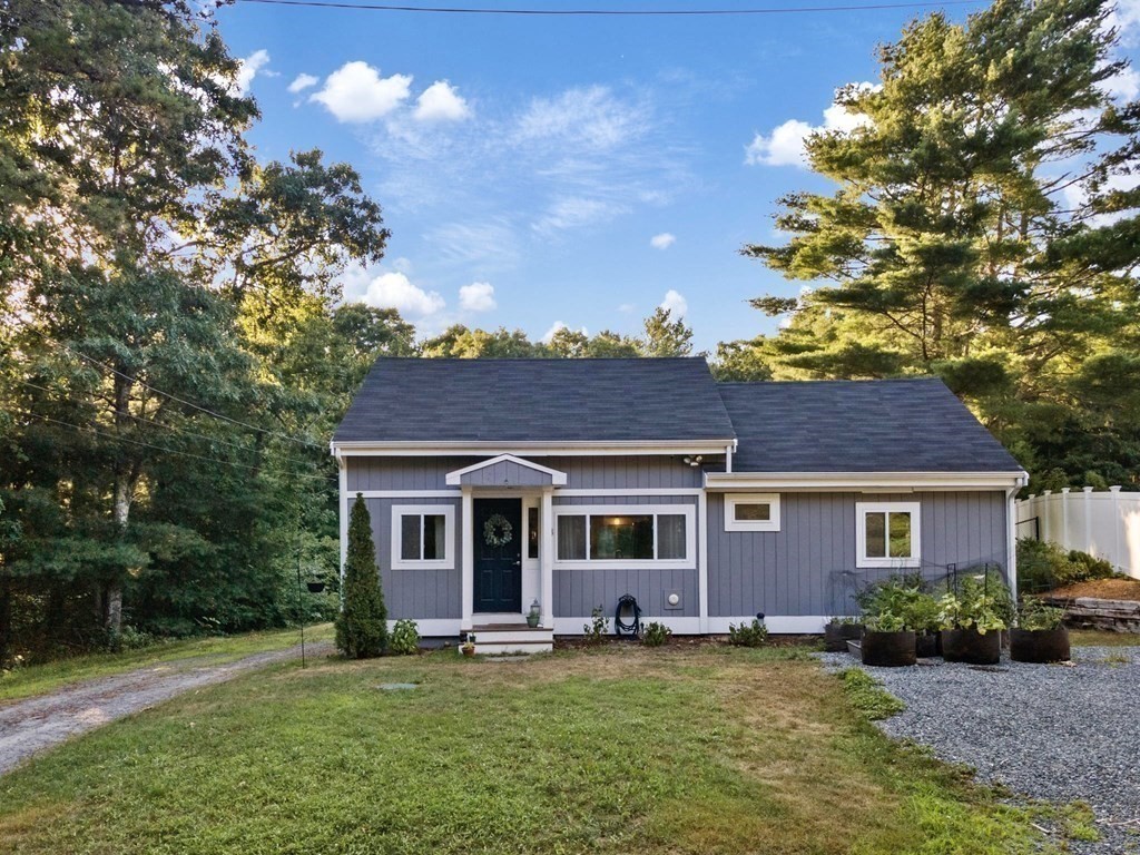 8 Squirrel Road Plymouth, MA 02360 - Photo 1 of 42 a view of a yard in front of a house with plants and large tree