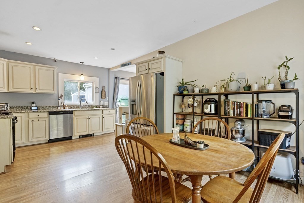 8 Squirrel Road Plymouth, MA 02360 - Photo 14 of 42 a kitchen with stainless steel appliances granite countertop a dining table chairs and granite counter tops