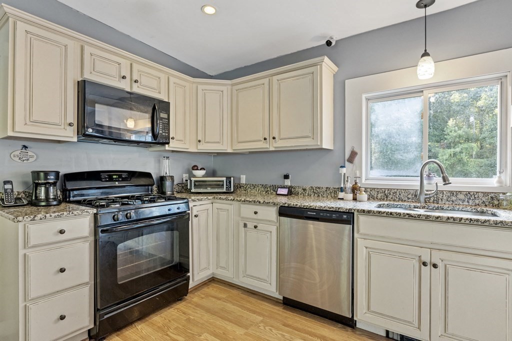 8 Squirrel Road Plymouth, MA 02360 - Photo 17 of 42 a kitchen with granite countertop white cabinets and white appliances