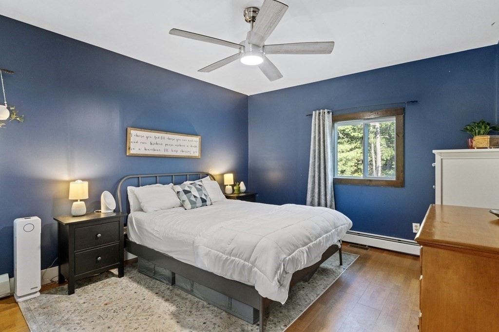 8 Squirrel Road Plymouth, MA 02360 - Photo 22 of 42 a bedroom with a bed and a chandelier