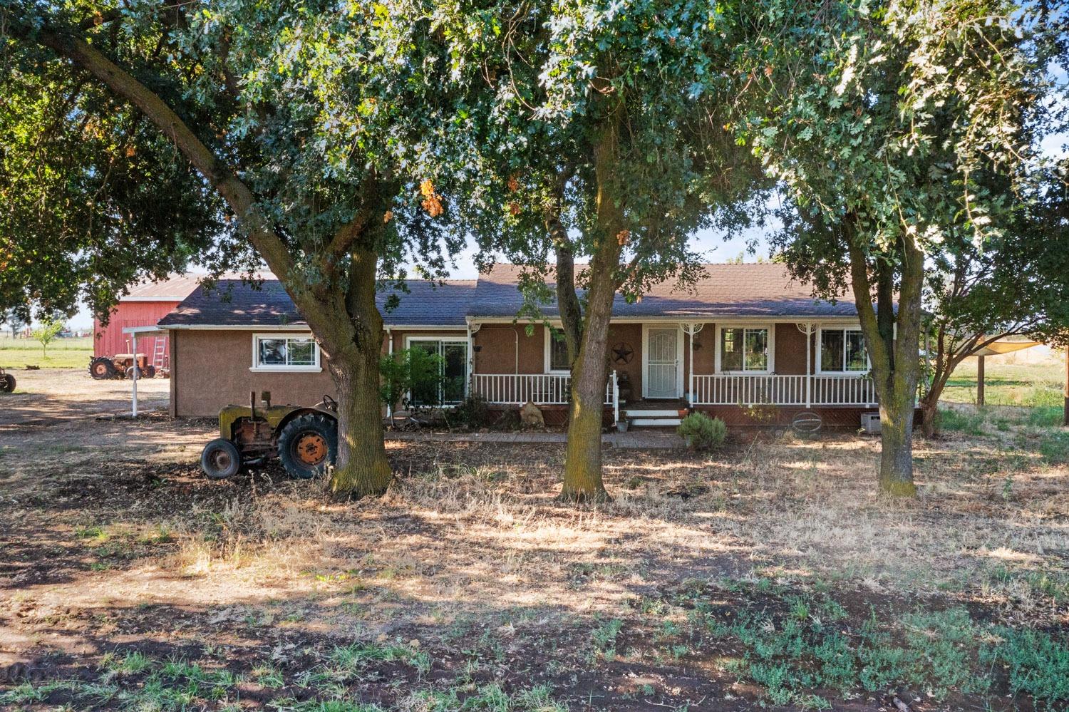 29144 Lone Tree Road Oakdale, CA 95361 - Photo 1 of 1 a front view of a house with a large tree