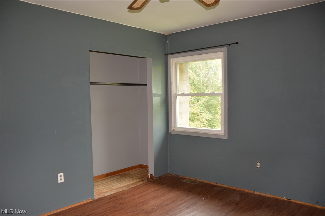 2791 Roberts Rdg Saint Joseph Road Moundsville, WV 26041 - Photo 19 of 24 Unfurnished bedroom with multiple windows, ceiling fan, a closet, and light hardwood floors
