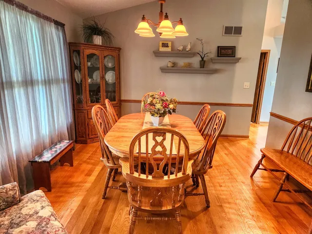 a dining room with furniture and a chandelier