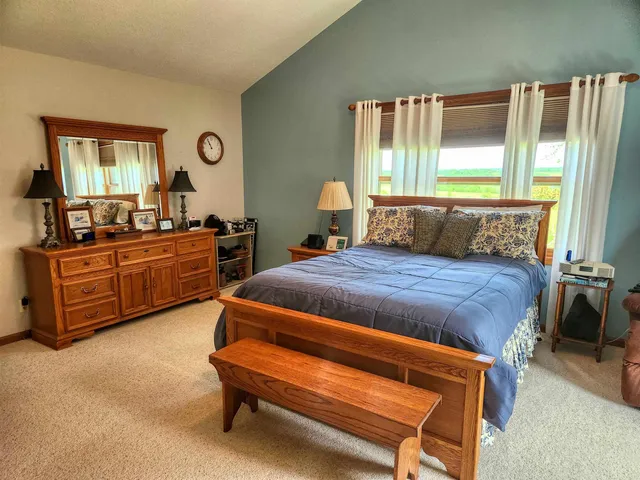 a bedroom with a bed and windows