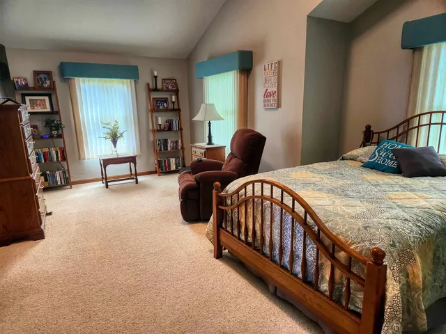 a bedroom with a bed and dresser